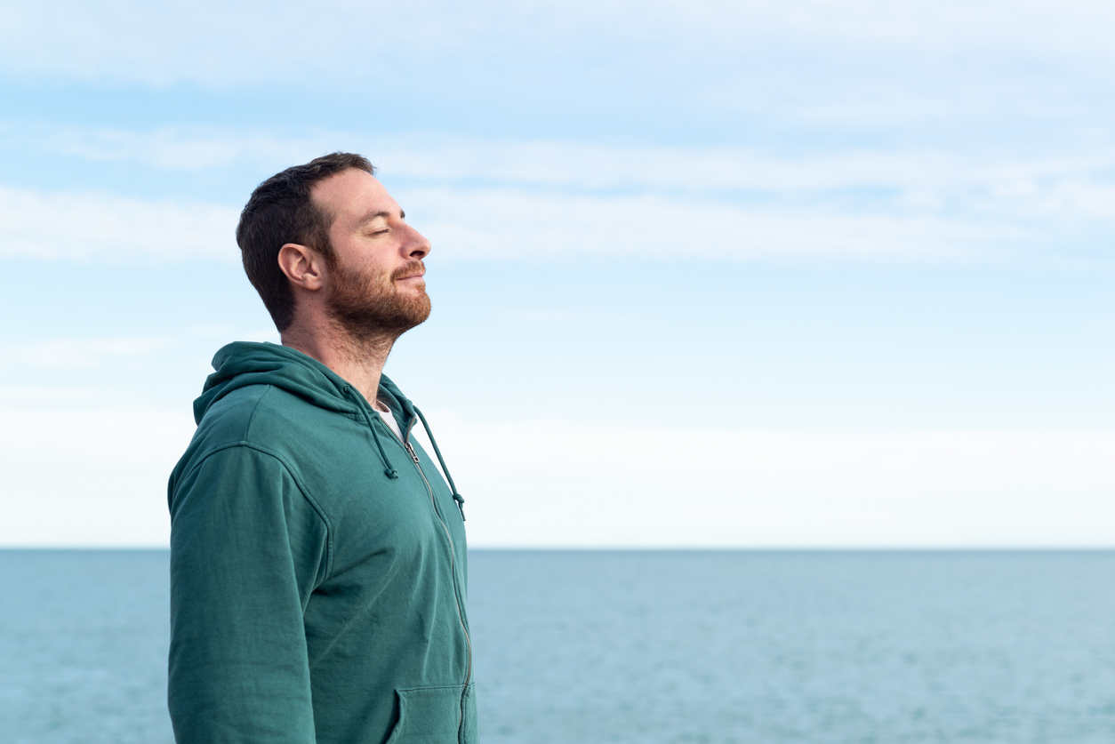 man by ocean who learned how to reduce stress and anxiety