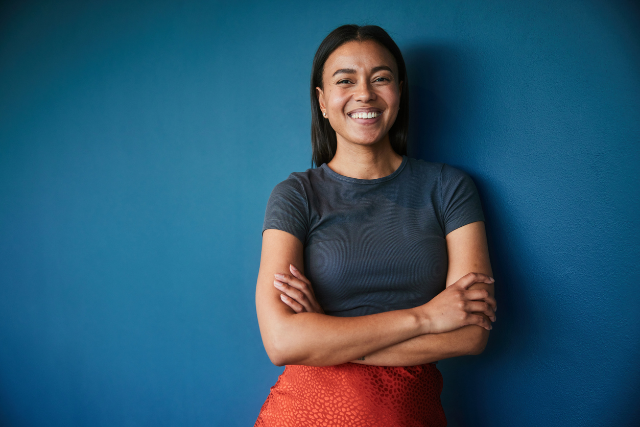 woman smiling after exploring the different types of therapy for trauma