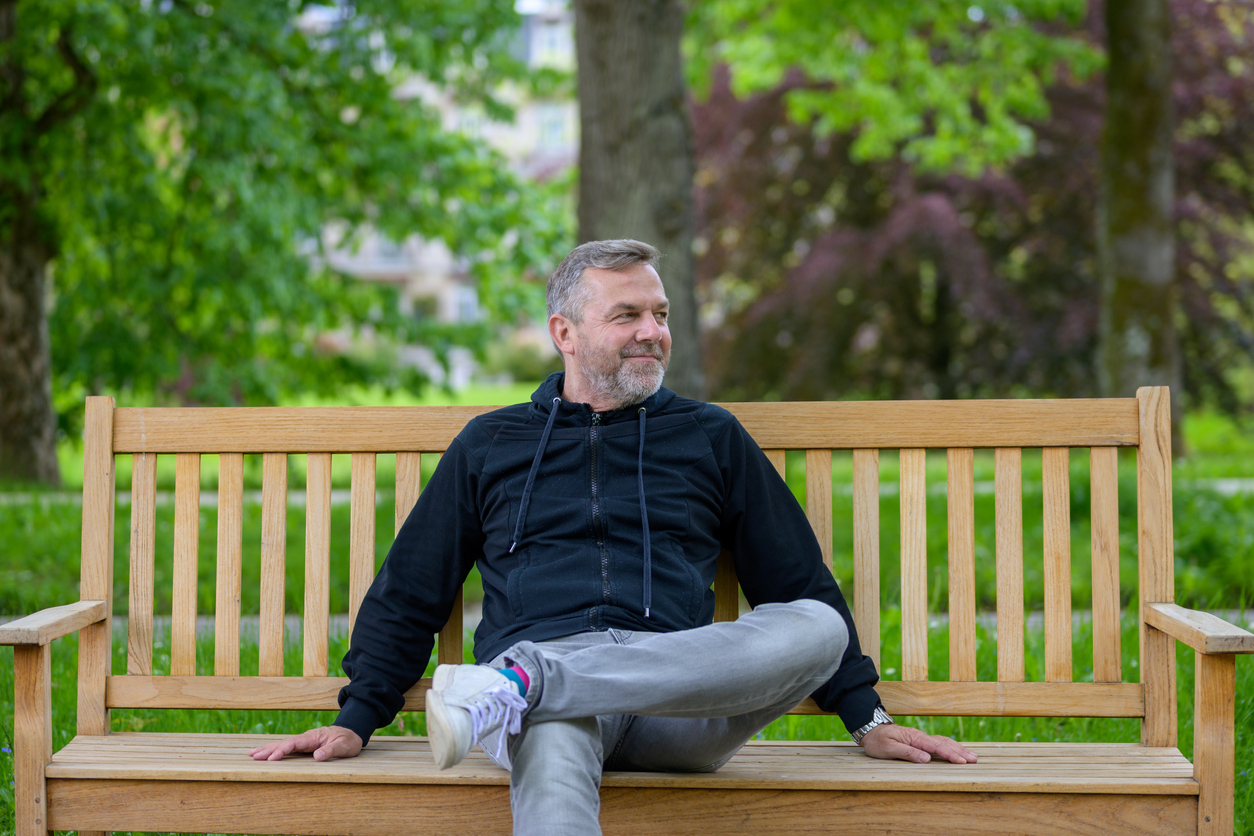man sitting in park after successful ketamine treatment for ptsd